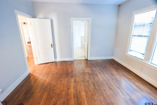 spare room with dark wood-type flooring