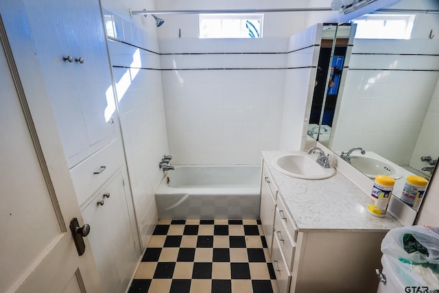 full bathroom with vanity, toilet, and tiled shower / bath combo