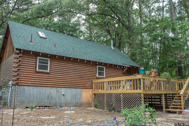 21544 Birch Pl, Tyler, TX 75705 - rear view of house featuring a deck, roof with shingles, log exterior, and stairs