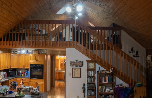 21544 Birch Pl, Tyler, TX 75705 - kitchen with black appliances, a ceiling fan, wood ceiling, high vaulted ceiling, and light wood-style flooring