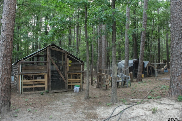 21544 Birch Pl, Tyler, TX 75705 - view of poultry coop featuring a view of trees