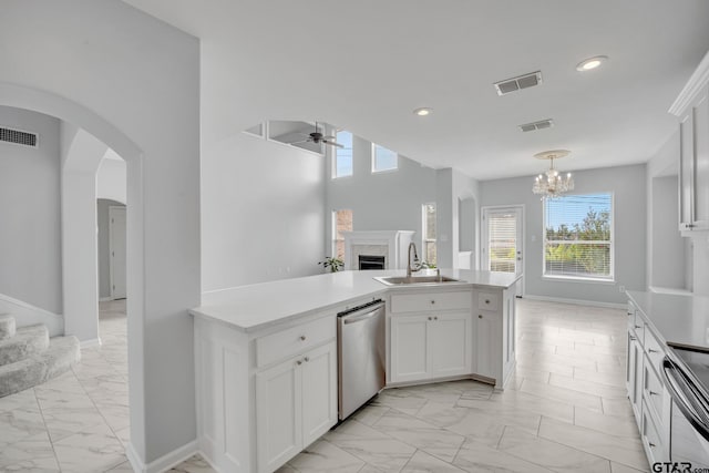 kitchen featuring white cabinets, sink, a healthy amount of sunlight, and stainless steel appliances