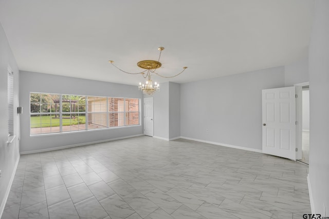 unfurnished room featuring an inviting chandelier