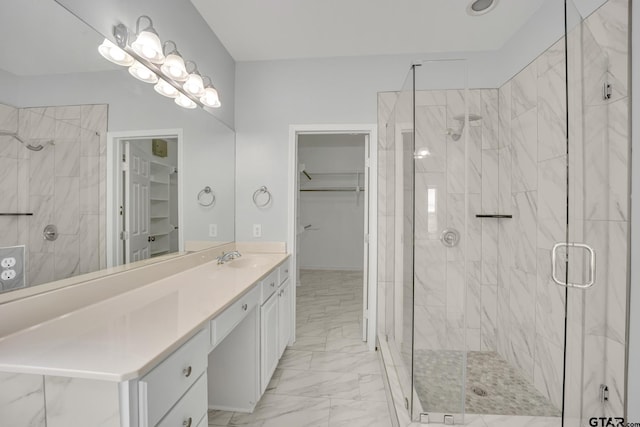 bathroom with vanity and a shower with door