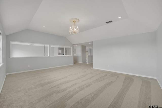 unfurnished living room with light colored carpet, a notable chandelier, and lofted ceiling