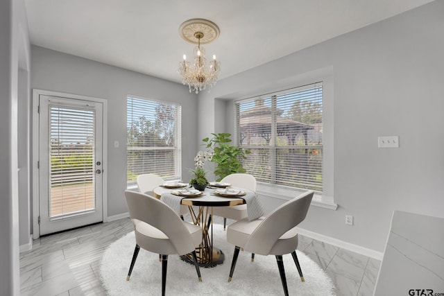 dining room featuring plenty of natural light and an inviting chandelier