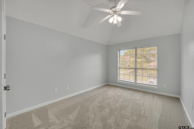 unfurnished room featuring lofted ceiling, carpet, and ceiling fan