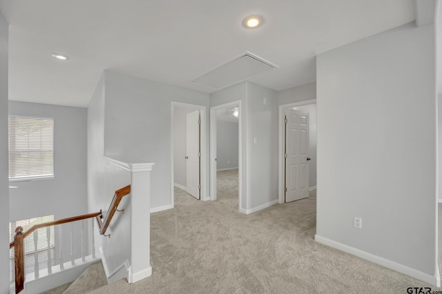 hall featuring light colored carpet