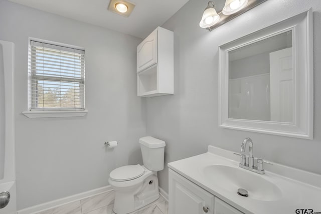 bathroom featuring a shower, vanity, and toilet