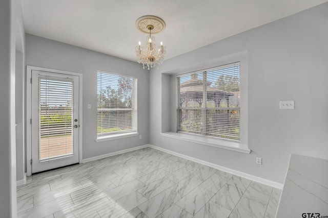 unfurnished dining area featuring a healthy amount of sunlight and an inviting chandelier