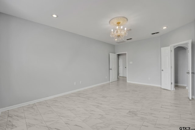 empty room with a notable chandelier