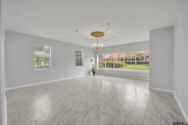 empty room featuring a notable chandelier