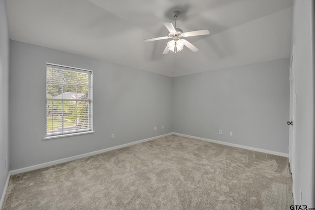 unfurnished room with ceiling fan and light carpet