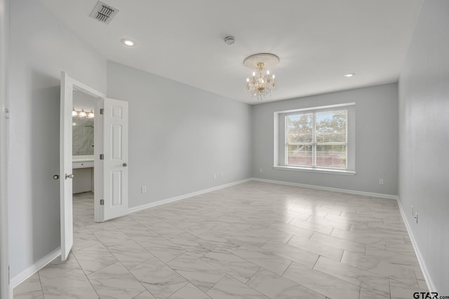 empty room with a notable chandelier