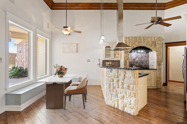 kitchen featuring a high ceiling, a ceiling fan, and baseboards