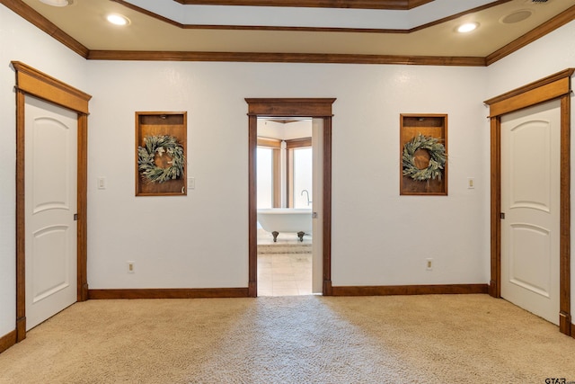 unfurnished bedroom with light carpet, ornamental molding, and baseboards