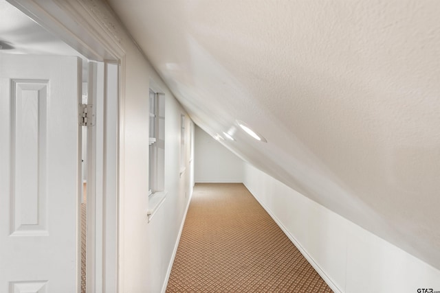 bonus room featuring lofted ceiling and baseboards