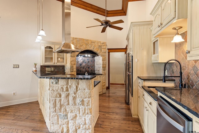 kitchen featuring tasteful backsplash, glass insert cabinets, exhaust hood, hardwood / wood-style floors, and dishwasher