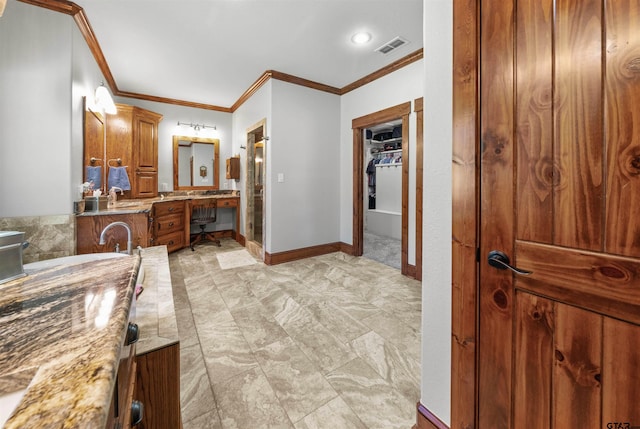 bathroom featuring ornamental molding, vanity, and a bath