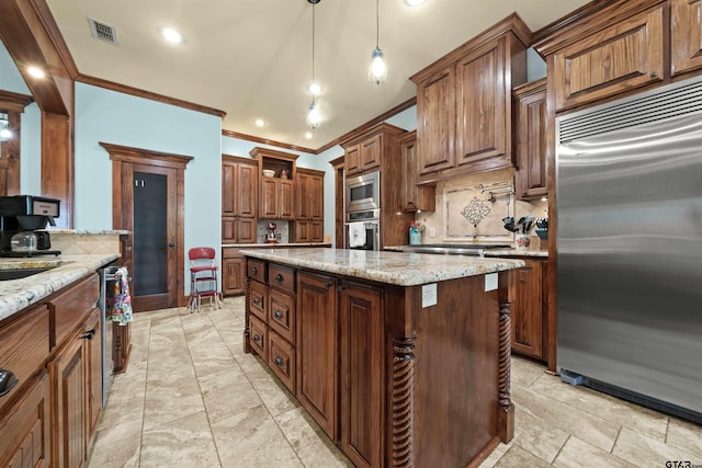 kitchen with a center island, built in appliances, hanging light fixtures, ornamental molding, and backsplash