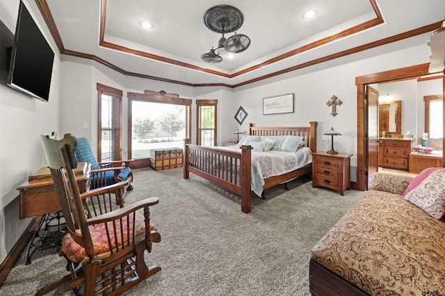 bedroom featuring light carpet, crown molding, and a tray ceiling