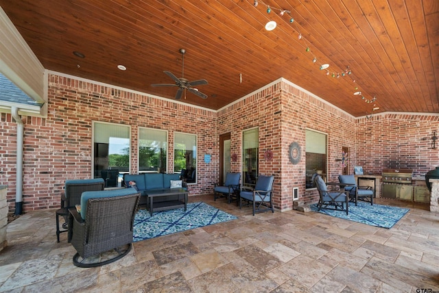 view of patio / terrace with area for grilling, ceiling fan, an outdoor living space, and exterior kitchen