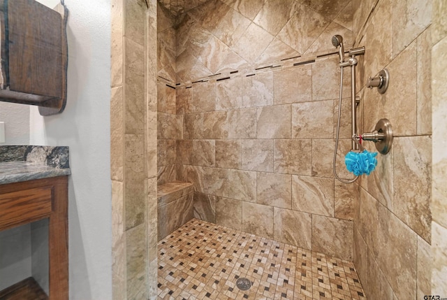 bathroom with vanity and tiled shower