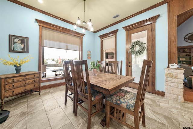 dining area featuring a chandelier, lofted ceiling, and crown molding