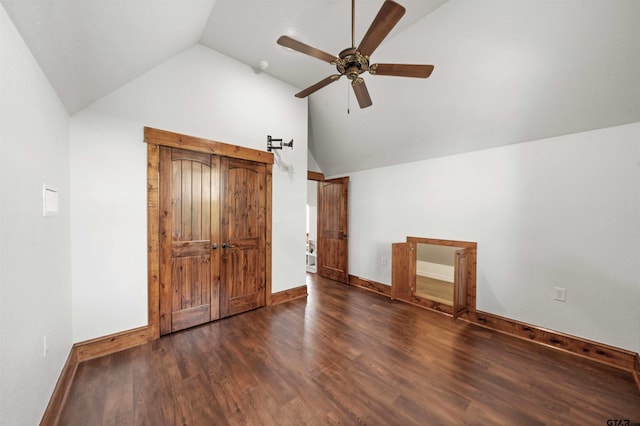 unfurnished bedroom featuring ceiling fan, dark hardwood / wood-style floors, and vaulted ceiling