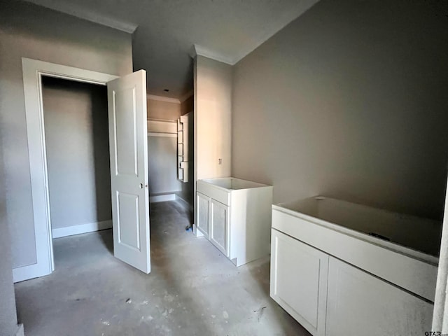 bathroom with concrete floors and crown molding