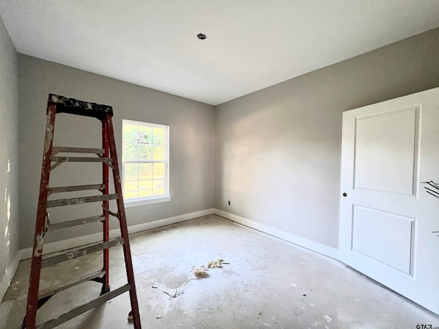 unfurnished bedroom with concrete floors