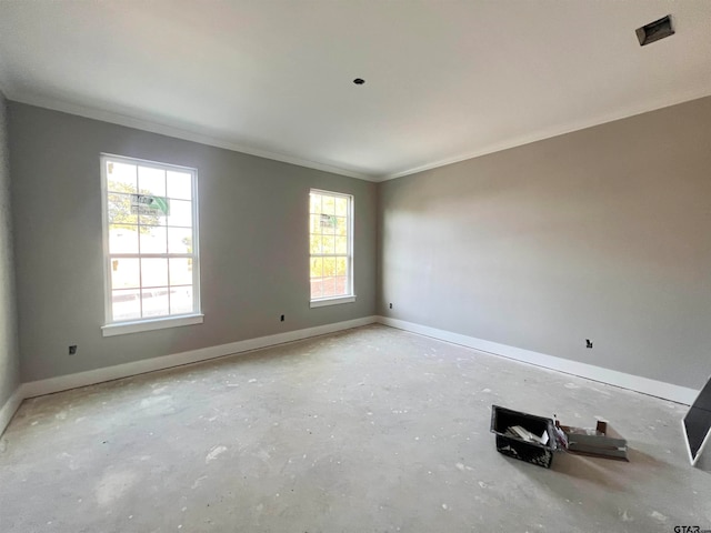 spare room featuring ornamental molding and a healthy amount of sunlight