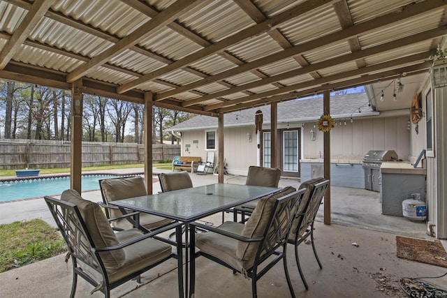 view of patio with a fenced in pool, area for grilling, and grilling area