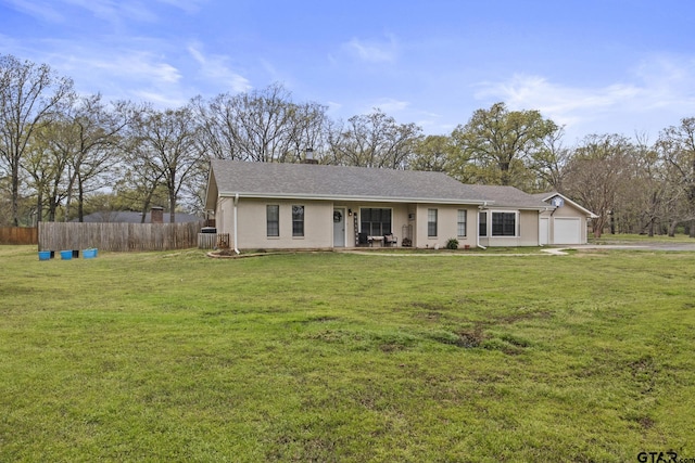 single story home with a front yard, central AC, and a garage