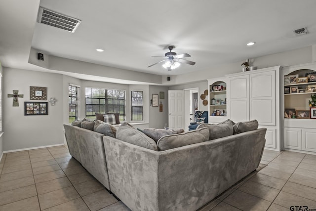 tiled living room with ceiling fan