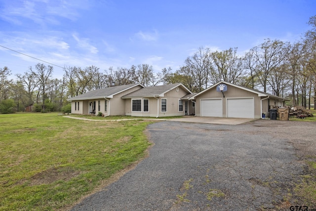 single story home featuring a garage and a front lawn