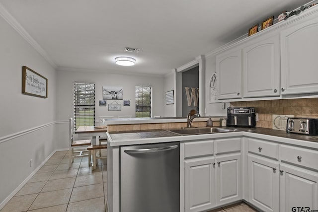 kitchen featuring white cabinets, dishwasher, light tile patterned flooring, and kitchen peninsula