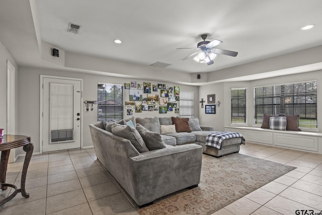 tiled living room with ceiling fan and plenty of natural light