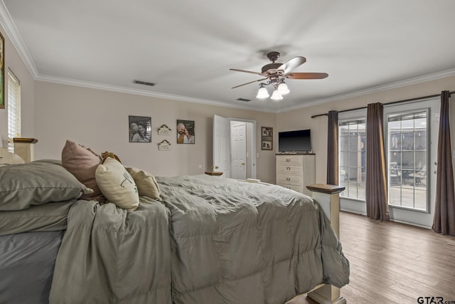 bedroom with hardwood / wood-style flooring, ceiling fan, and ornamental molding