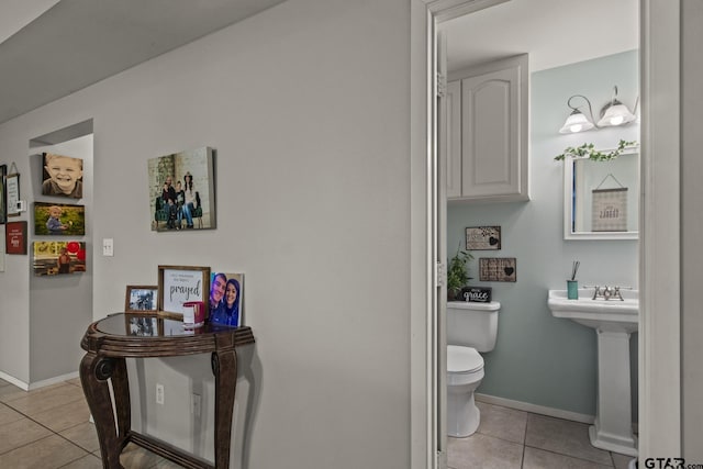 bathroom featuring toilet and tile patterned floors