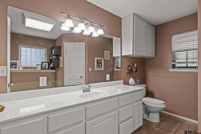 bathroom featuring tile patterned flooring, vanity, and toilet