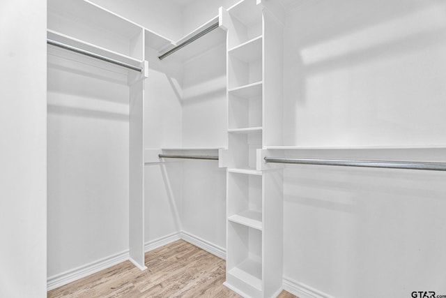 spacious closet with light hardwood / wood-style floors