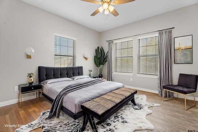 bedroom with ceiling fan and light hardwood / wood-style flooring