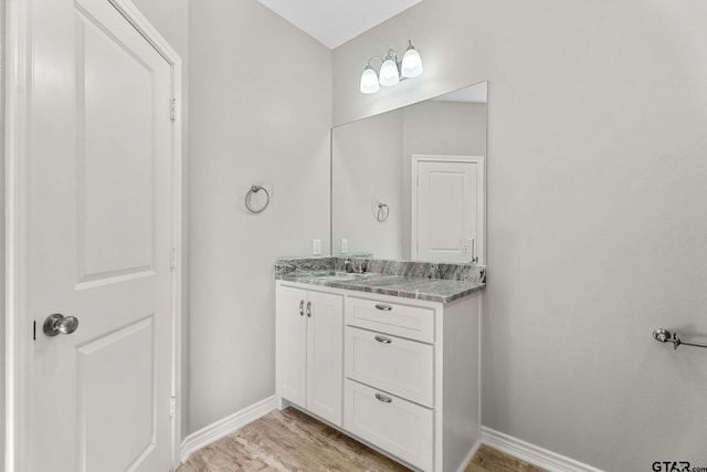 bathroom with vanity and hardwood / wood-style flooring