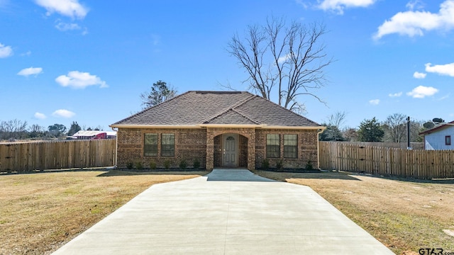 ranch-style home with a front lawn