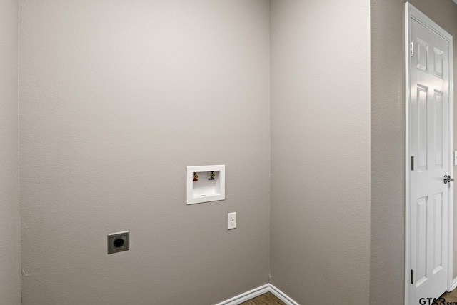 clothes washing area with hookup for an electric dryer, hookup for a washing machine, baseboards, and dark wood-style flooring