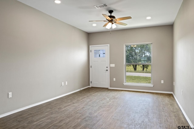 empty room with ceiling fan, wood finished floors, baseboards, and recessed lighting