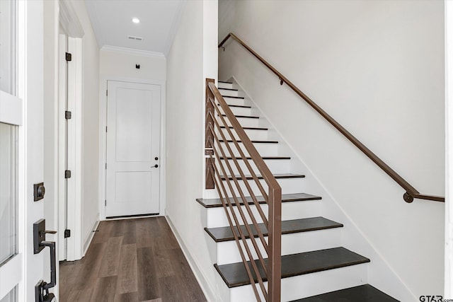 staircase featuring hardwood / wood-style flooring and ornamental molding