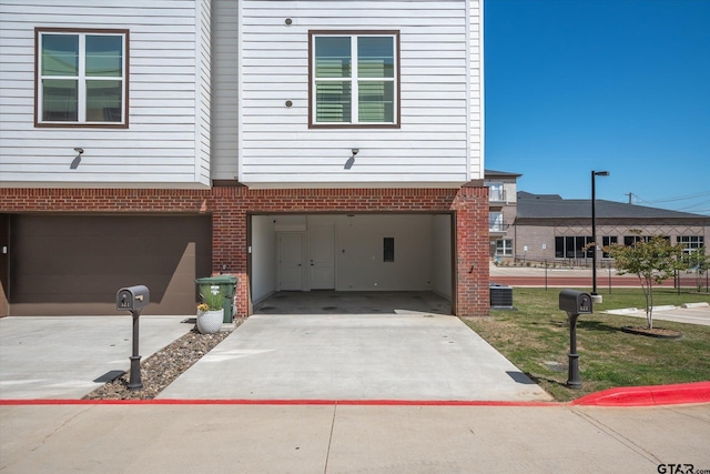 exterior space with a garage and cooling unit