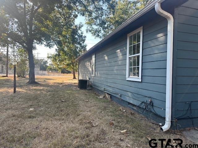 view of side of property featuring central air condition unit